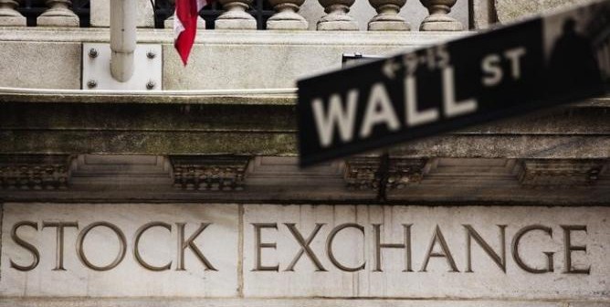 A street sign for Wall Street hangs in front of the New York Stock Exchange